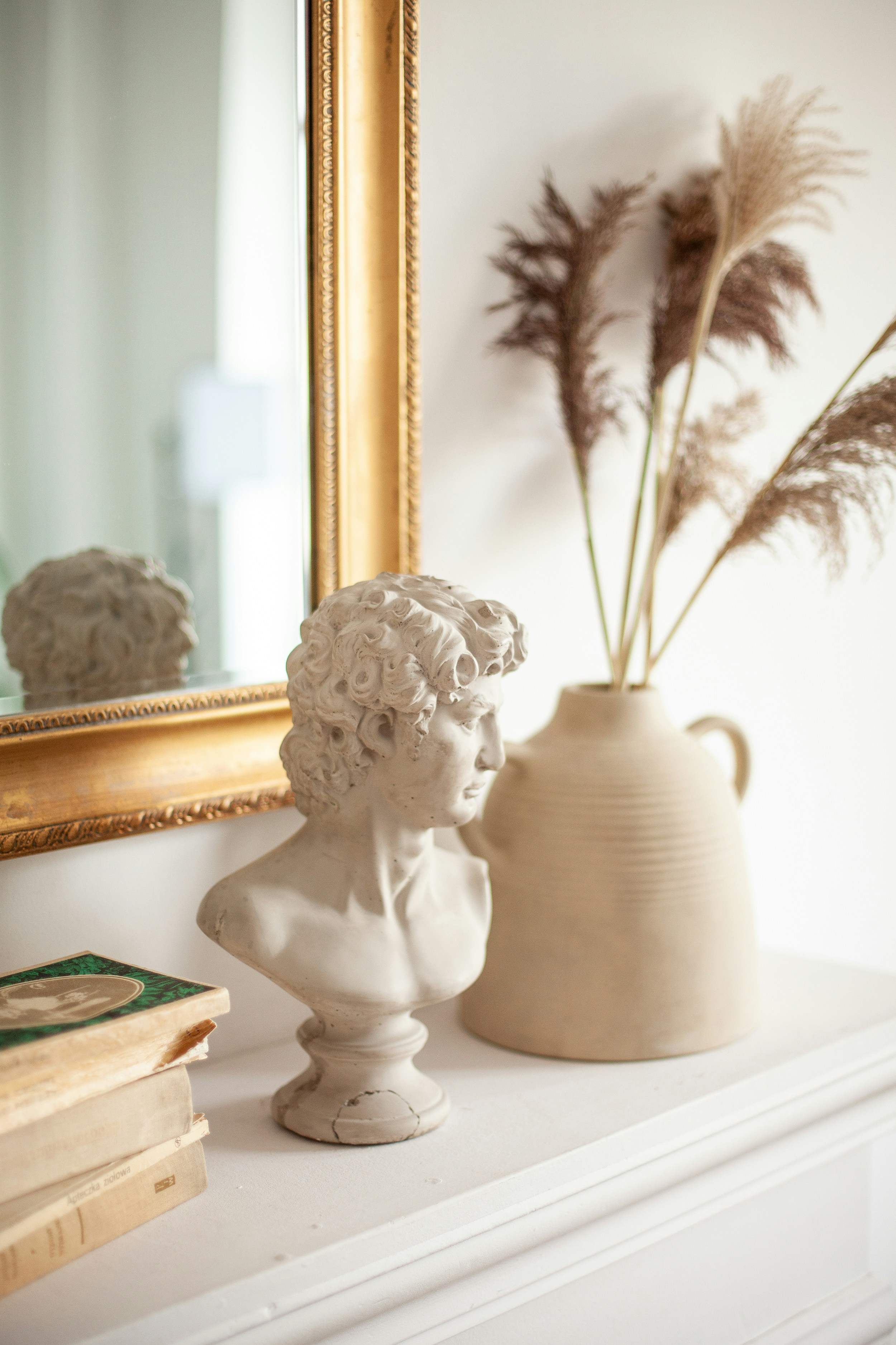 Editorial sitting room vignette with walnut chair and brass lamp